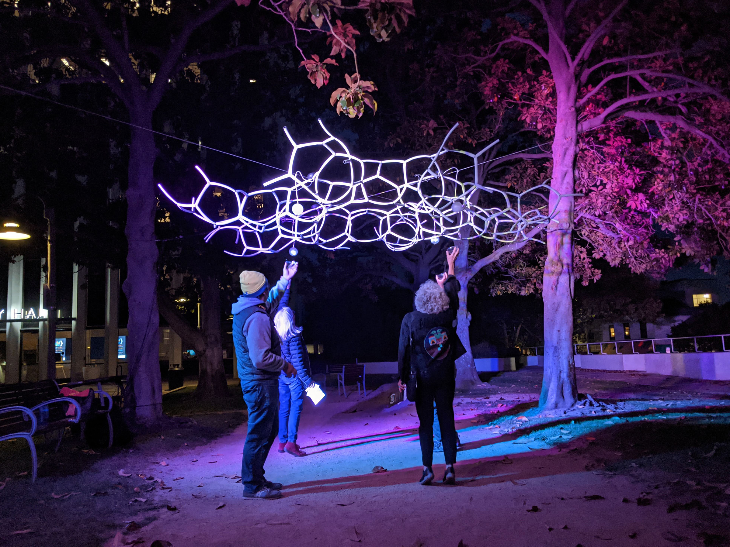 a sculpture suspended in trees
