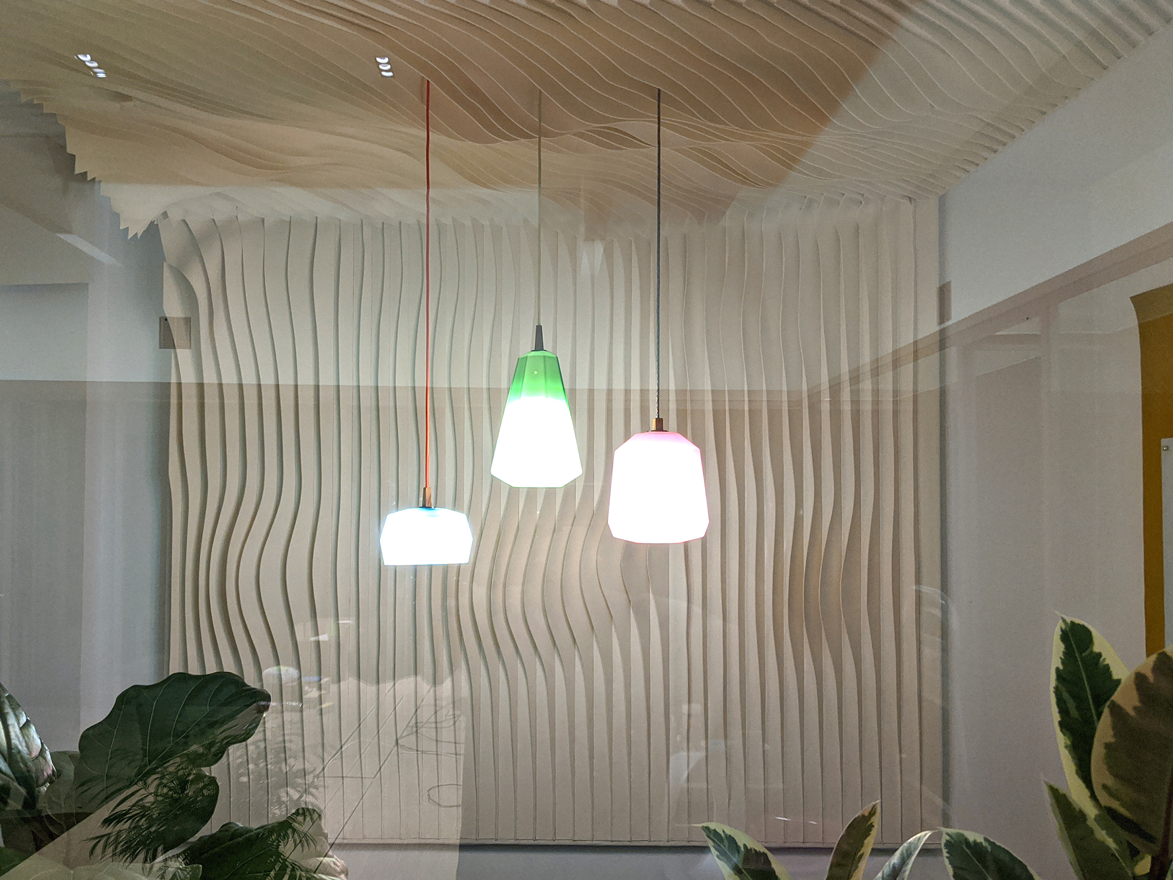 A felt installation on the wall and ceiling of a conference room